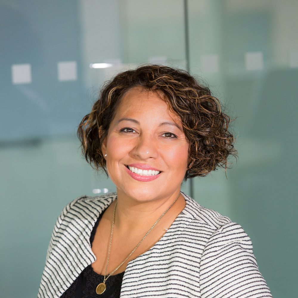 Smiling hiring manager in a modern glass-walled office